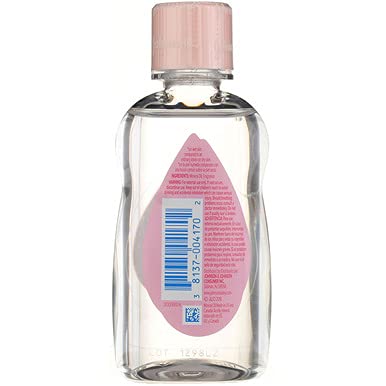 Johnson & Johnson Baby Oil bottle beside nursery items in a calm setting.