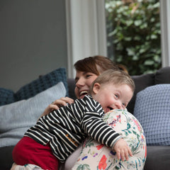 Family applying Johnson's Baby lotion to toddler's arms for dry skin relief