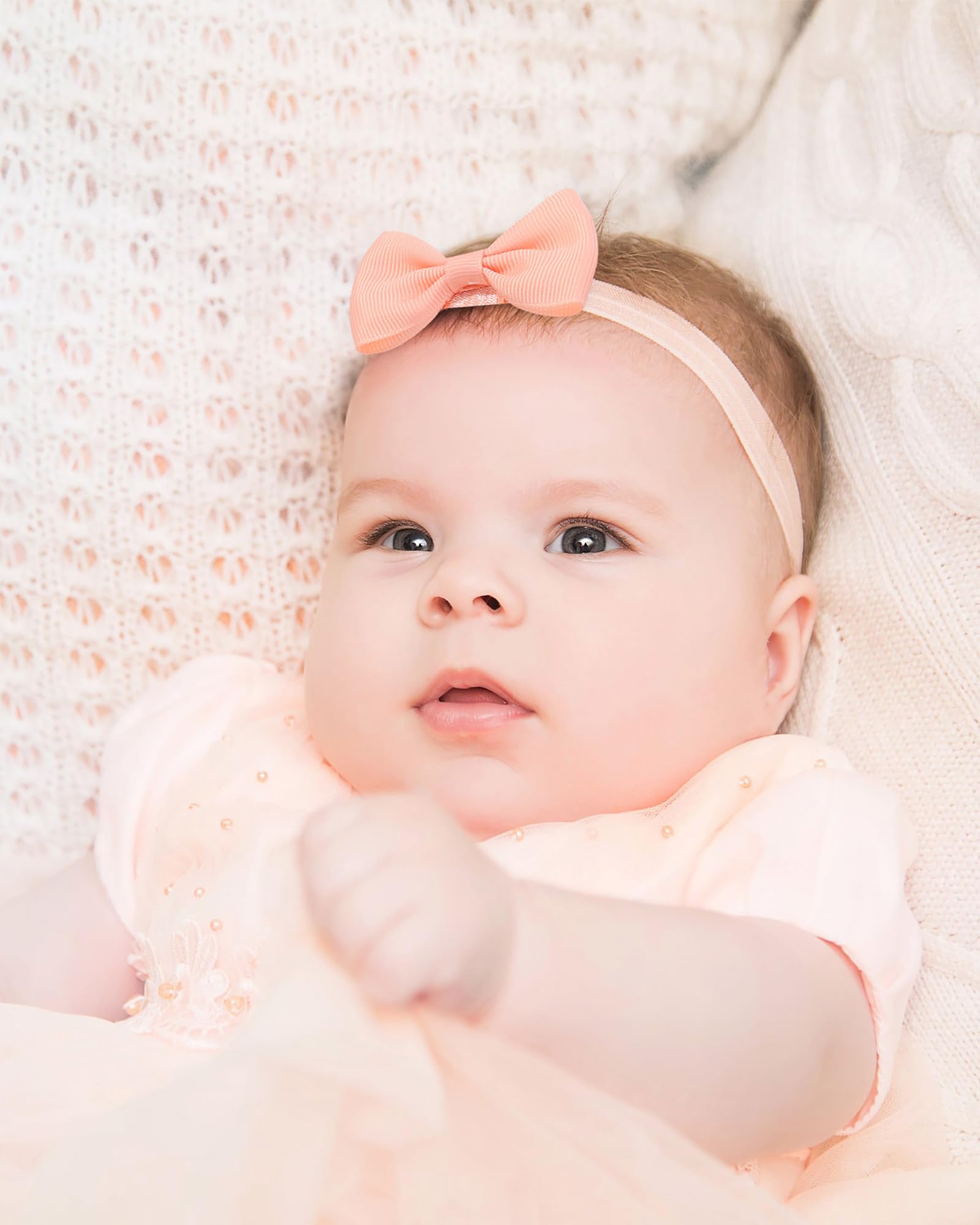 Jollybows photoshoot-ready headbands enhance newborn portraits.