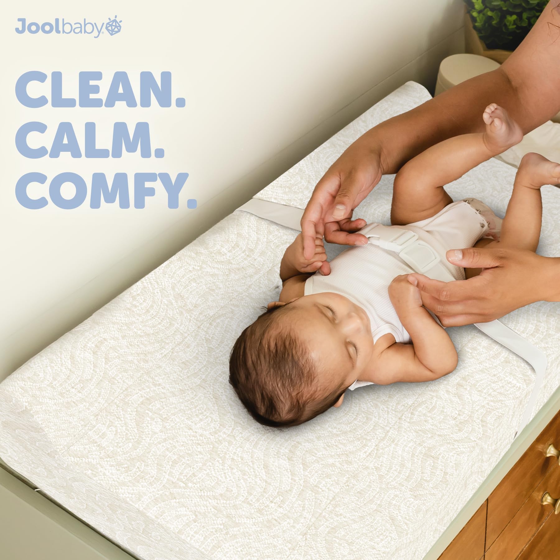 Jool Baby cover in use on dresser setup promotes quick, clean diaper changes.