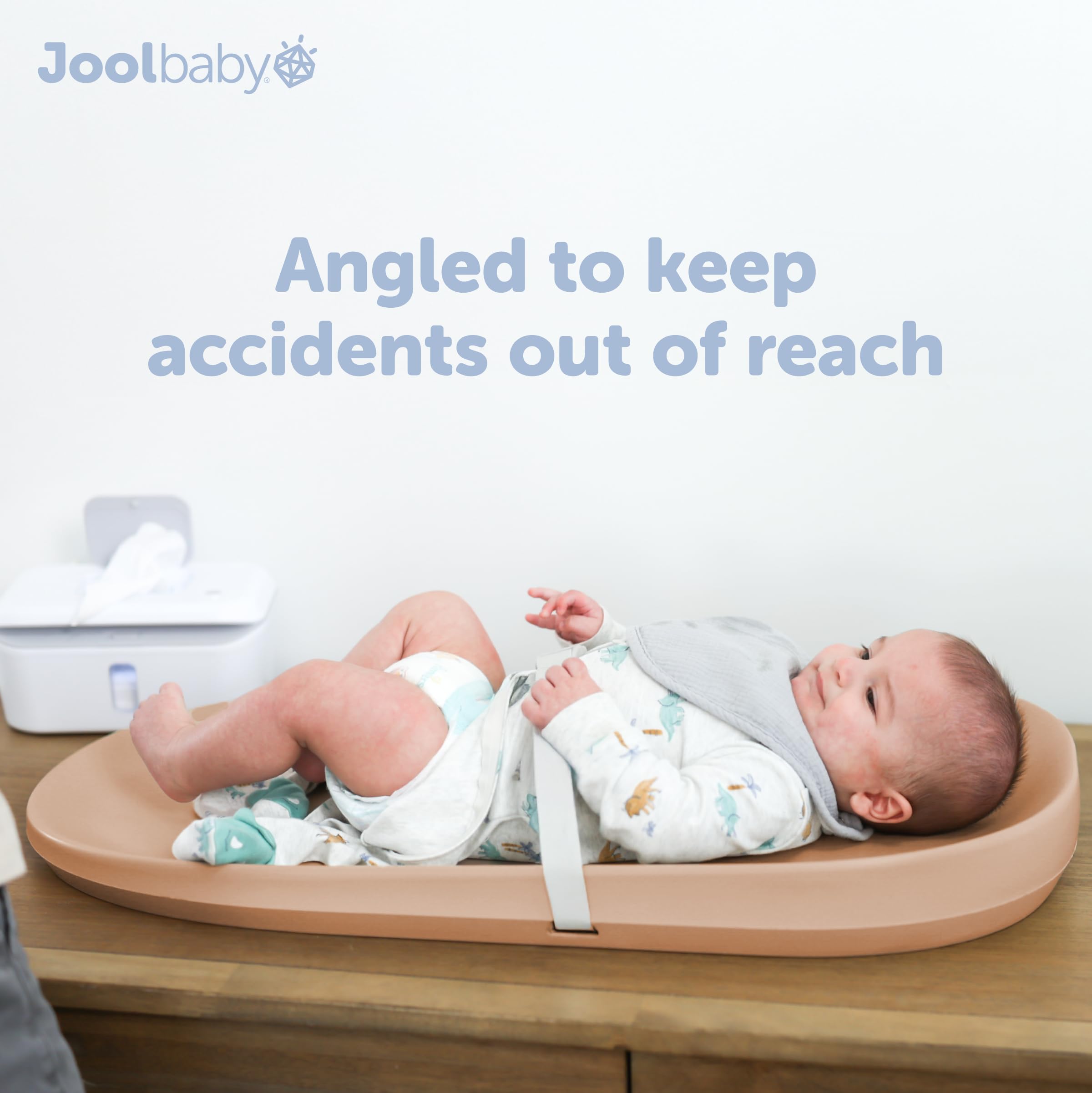 Jool Baby foam cushion close-up on peach changing pad.