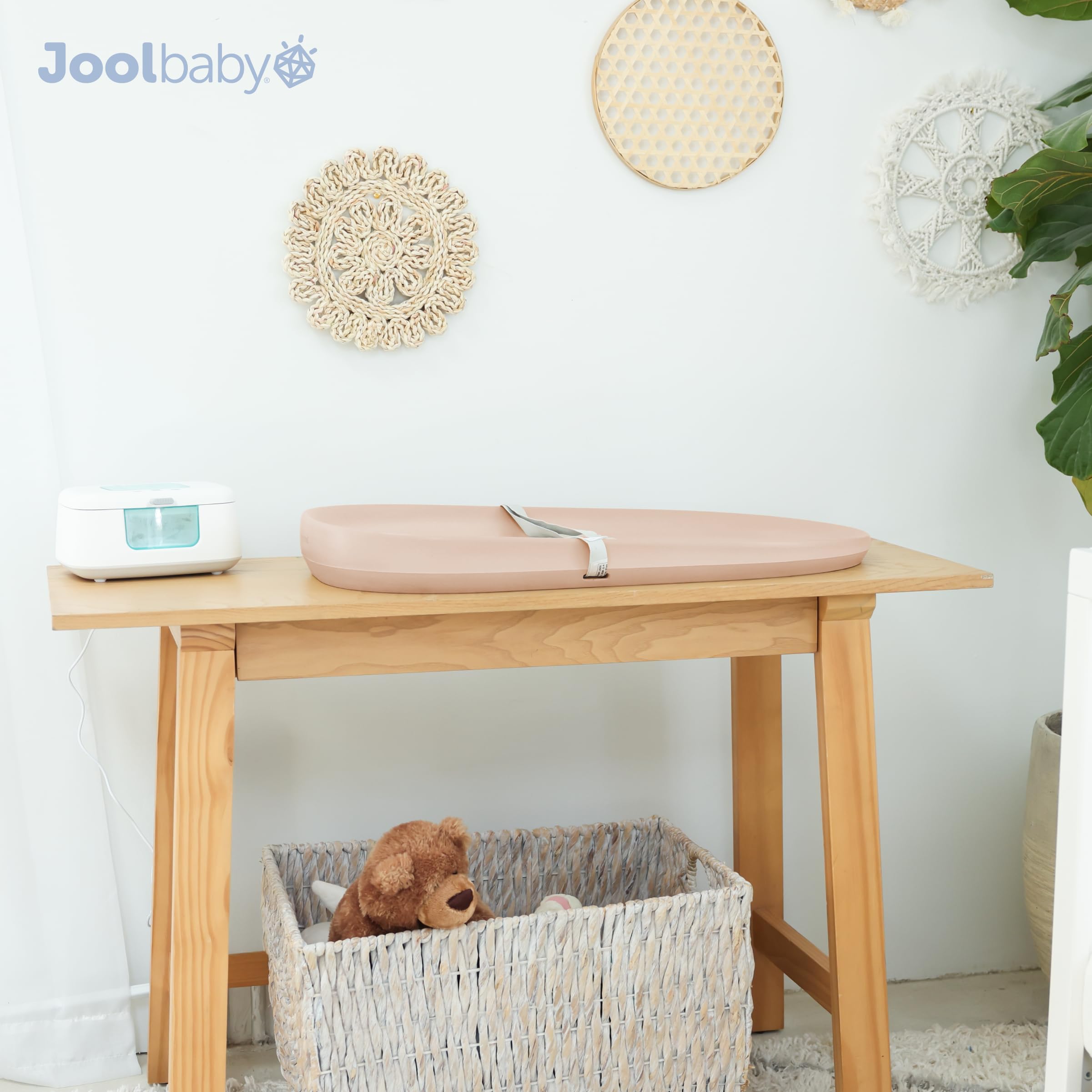 Jool Baby peach changing pad complements modern nursery decor.