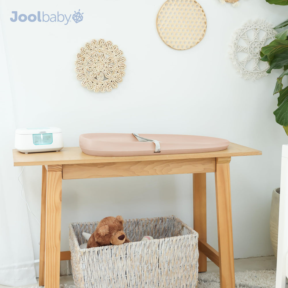 Jool Baby peach changing pad complements modern nursery decor.