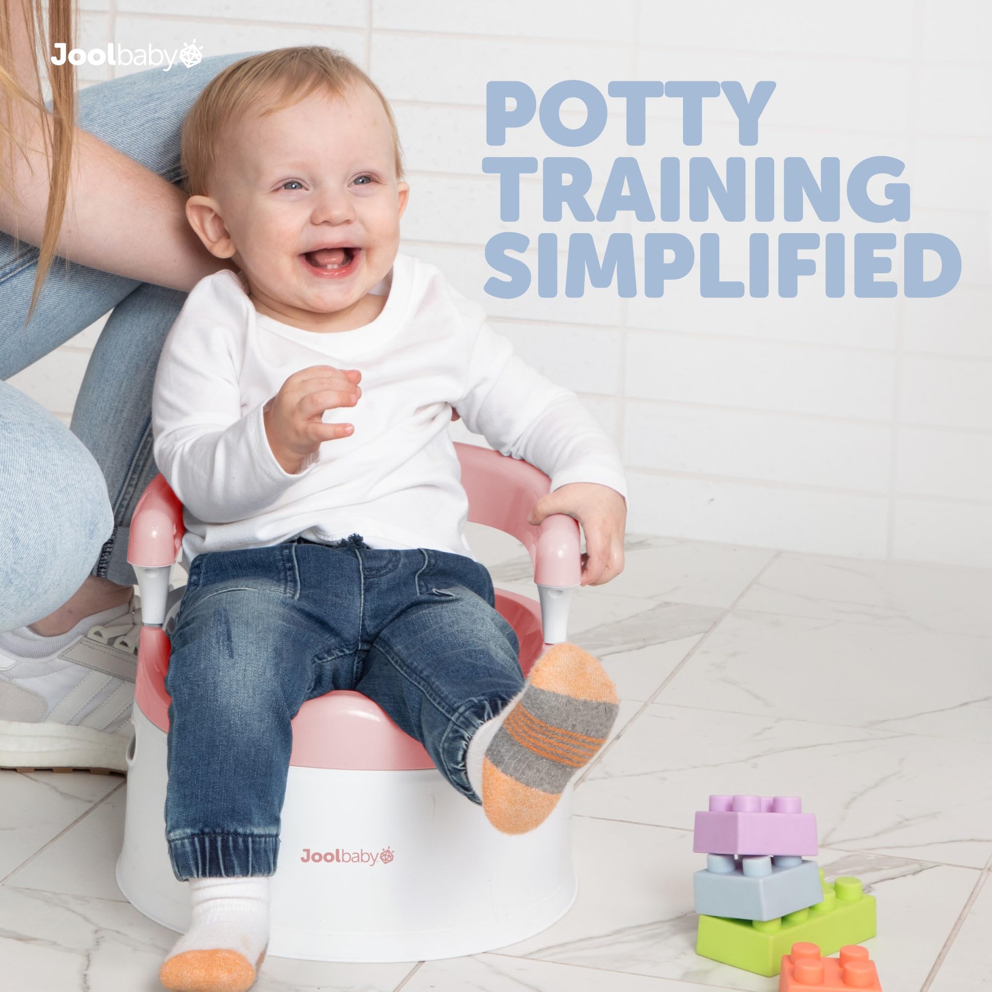 Jool Baby pink potty chair back support keeps toddlers secure.