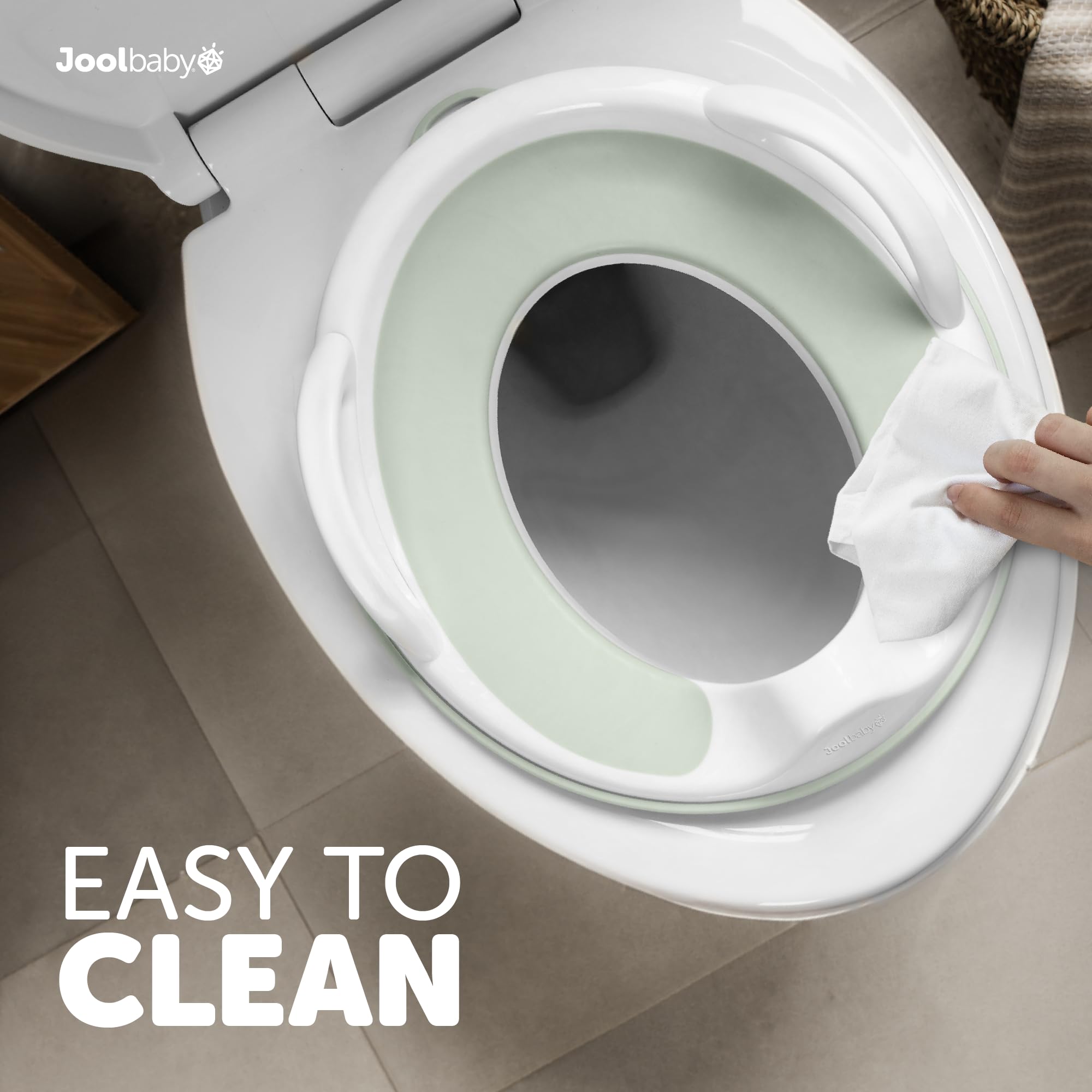 Jool Baby sage-color potty seat displayed in a calm bathroom setting.