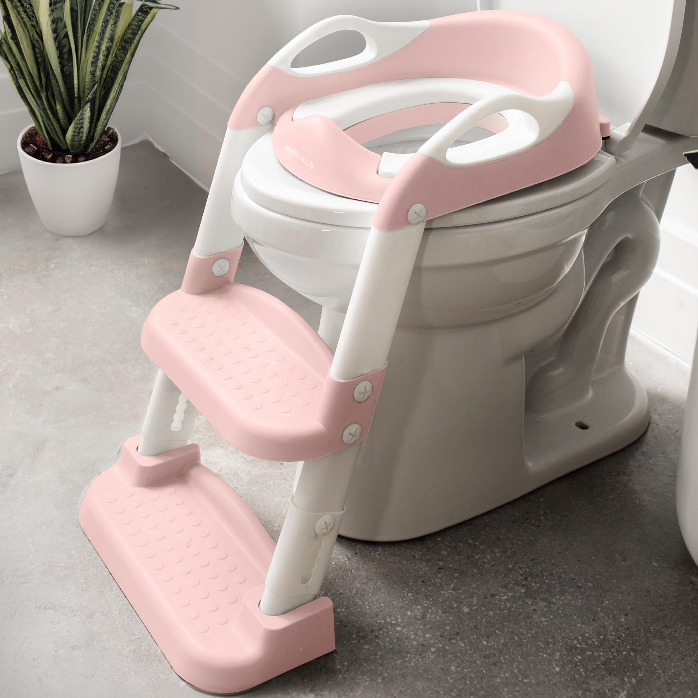 Jool Baby potty training seat with 2-step ladder in pink for independent toilet use.