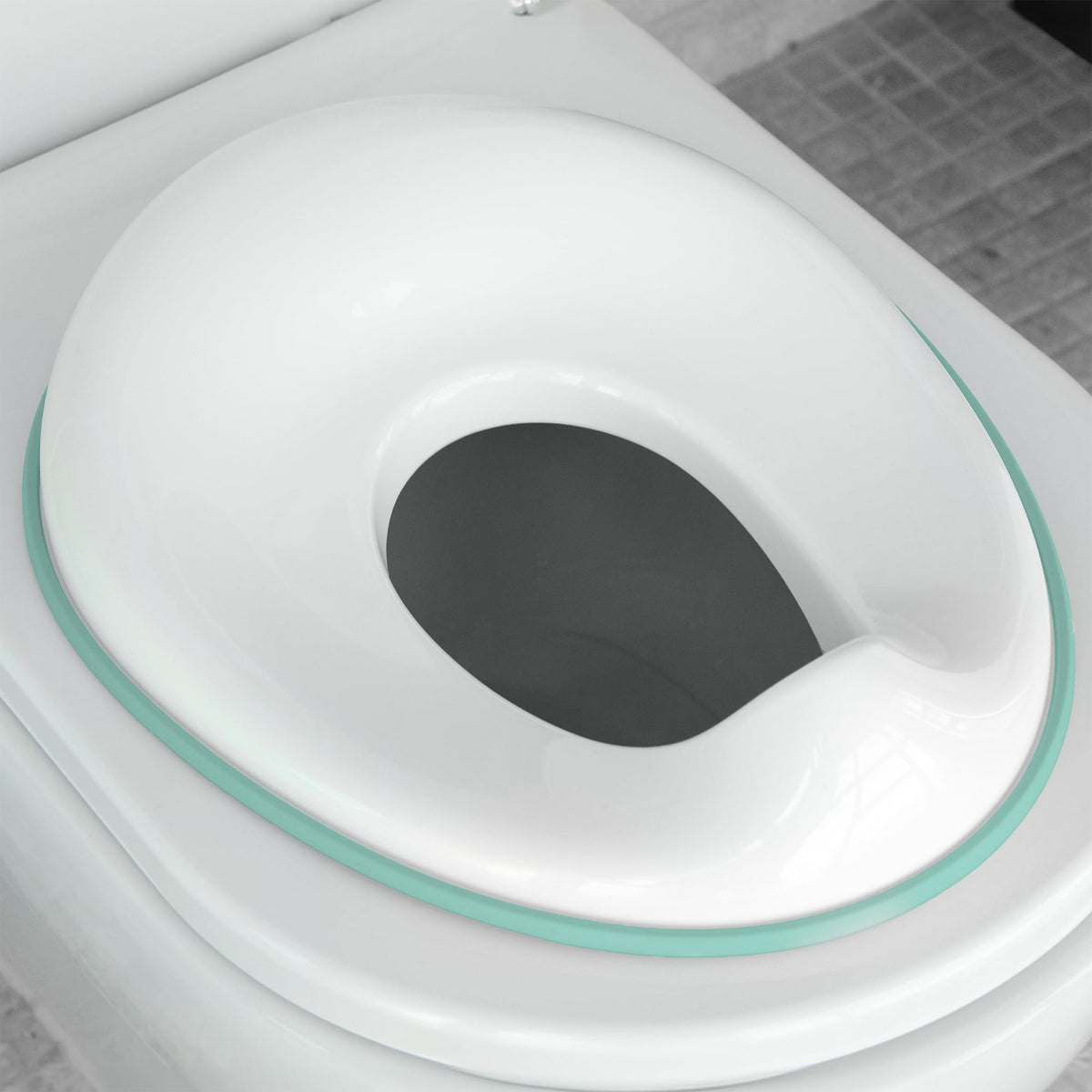 Jool Baby Aqua potty seat front view showing secure fit for kids