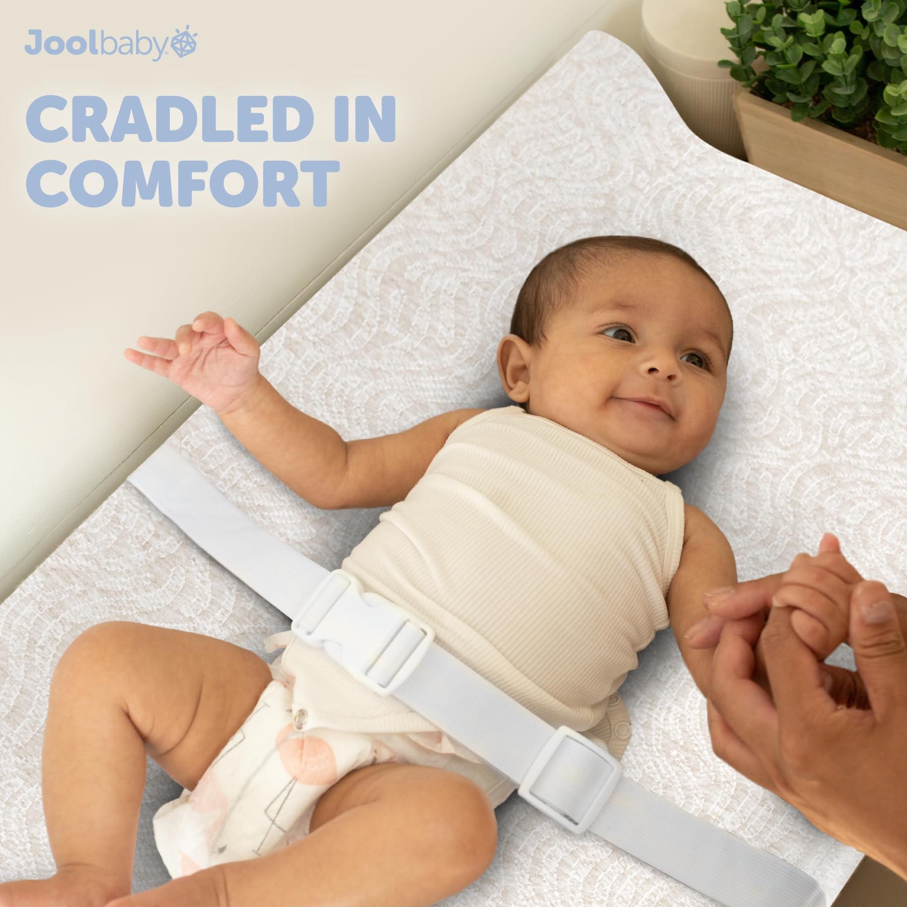 Jool Baby Serenity washable cover on changing pad for easy cleanup after messes
