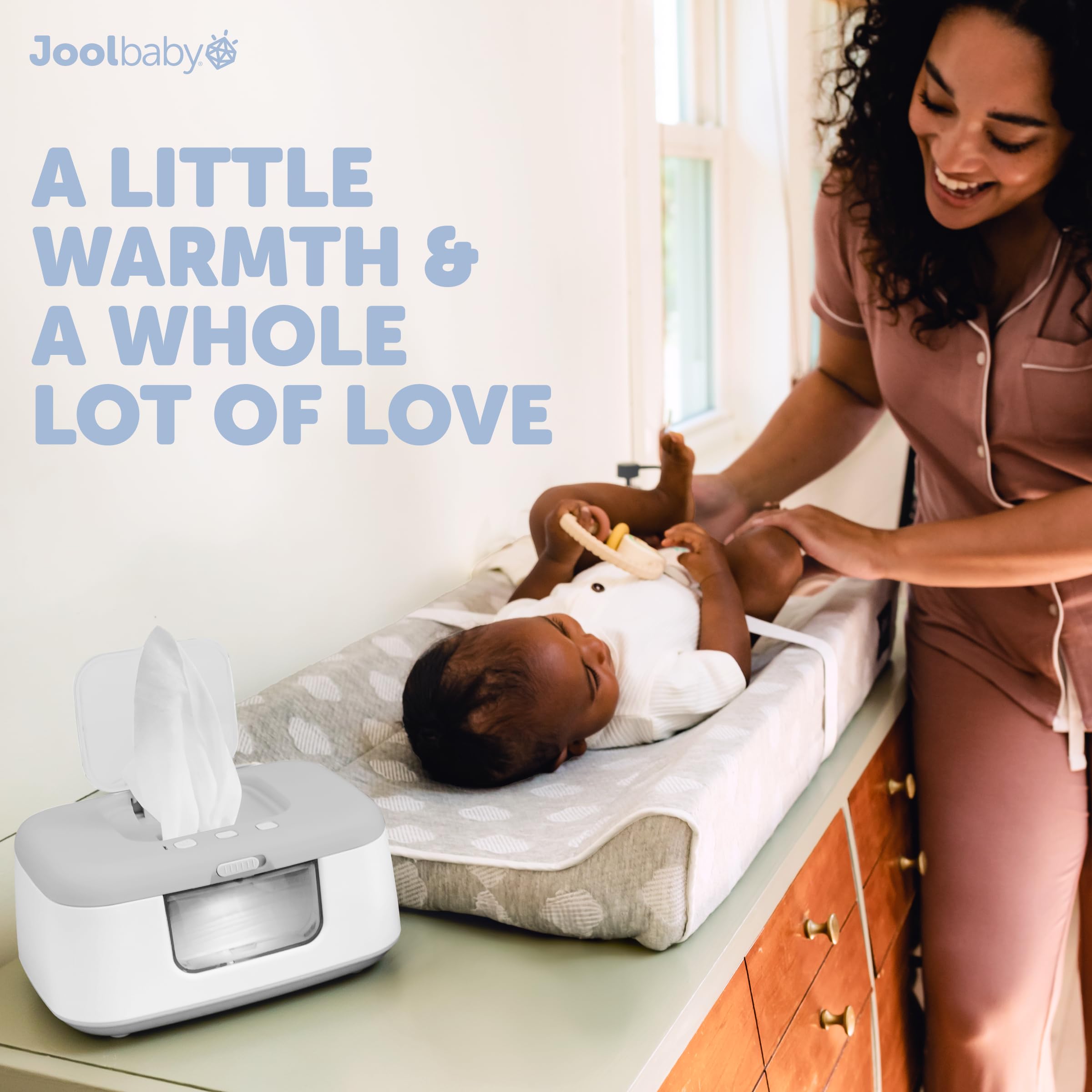 Jool Baby TinyBums wipe warmer in use during diaper changes.