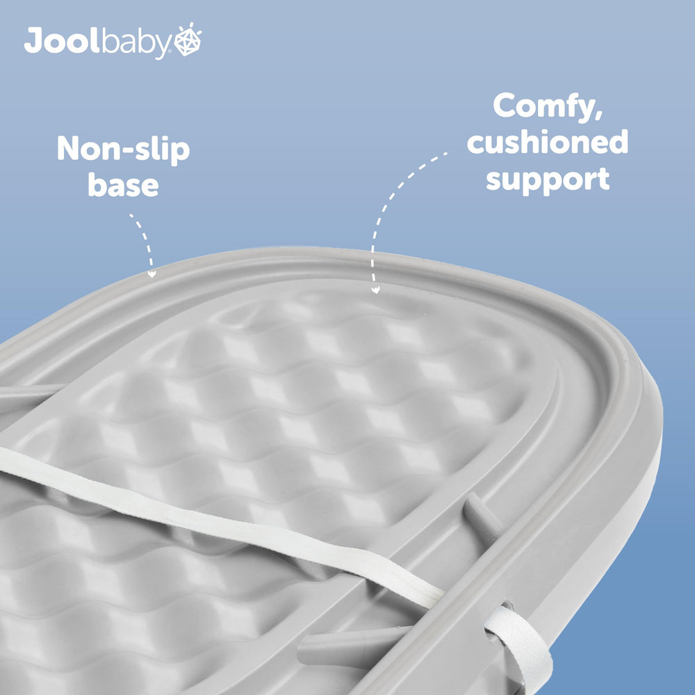 Jool Baby gray changing pad on a table for easy use.