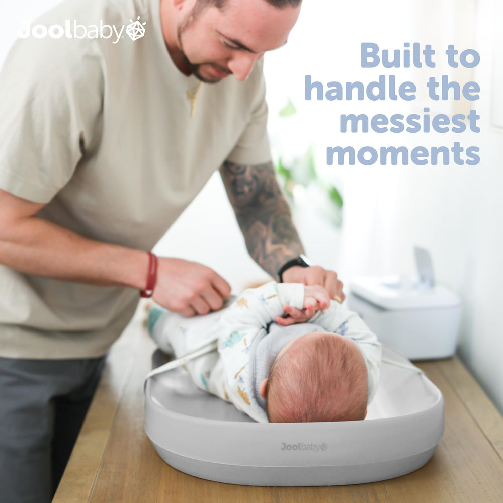 Jool Baby gray changing pad, side view, compact and portable.