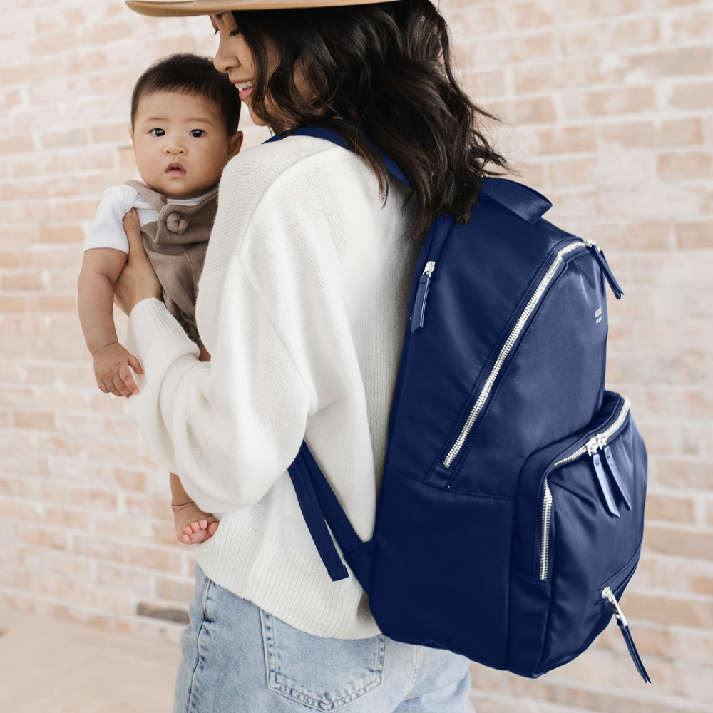 JuJuBe Everyday Diaper Backpack features a trolley strap for luggage compatibility.