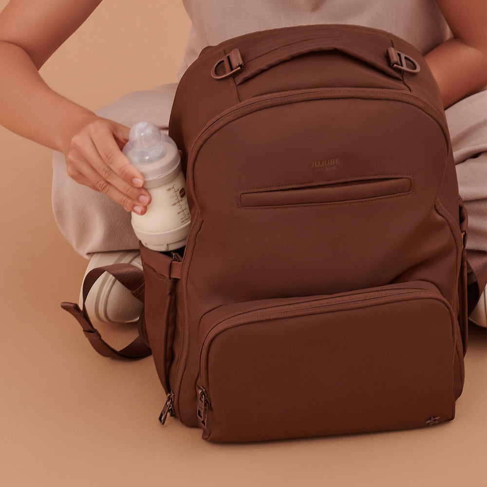 JuJuBe Espresso bag on stroller show with straps attached.