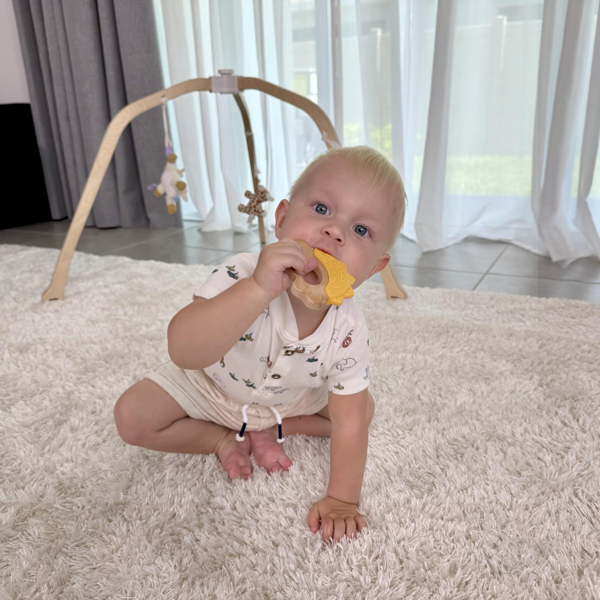 JUNUNA ergonomic grip teether blends wood and silicone for easy handling.