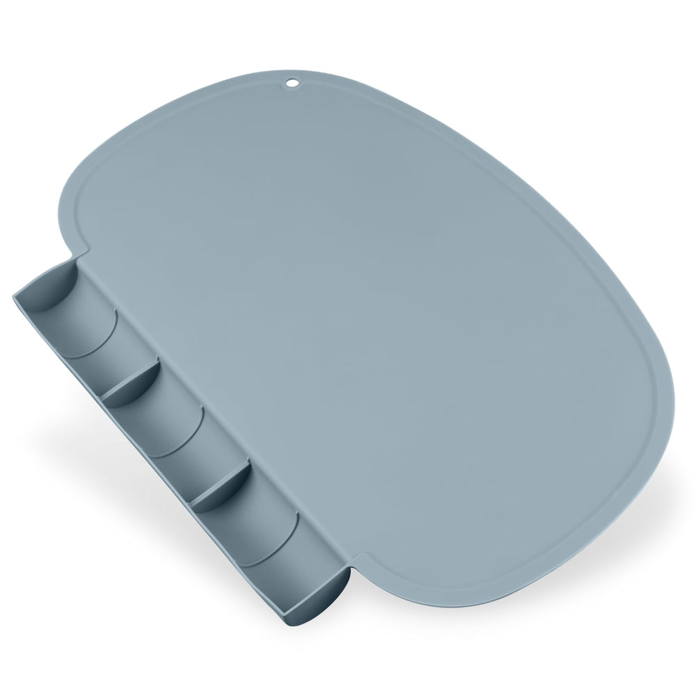 Kalovin silicone placemat with food catcher pockets on a flat dining table to catch spills.