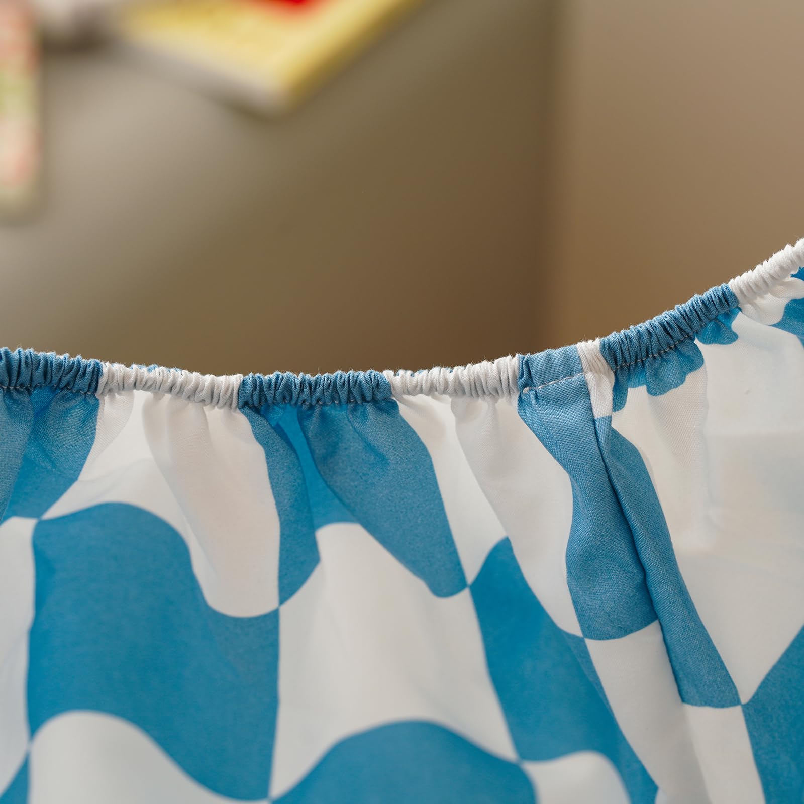 Room scene showing KAREVER Grid toddler bedding in blue checkered pattern for a calm sleep space