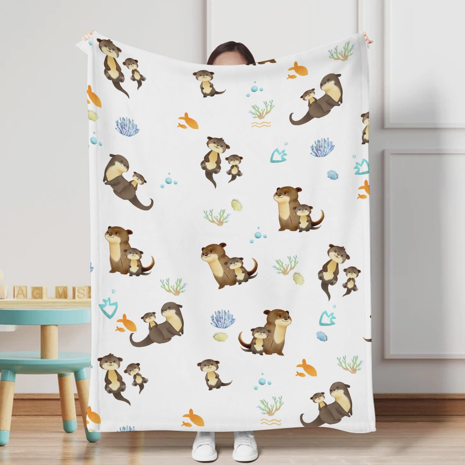 KASTLEE sea otter family print blanket adds playful nursery decor.