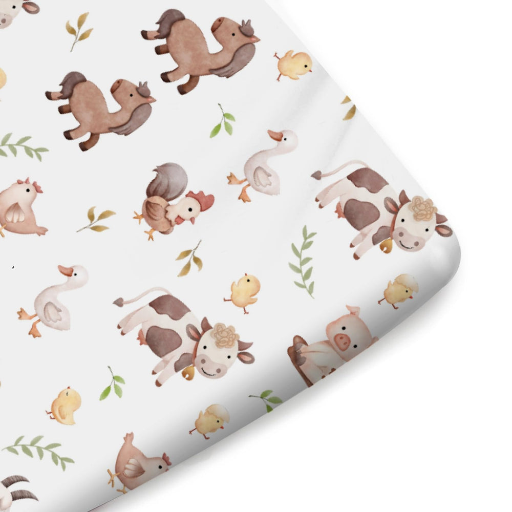 KASTLEE watercolor farm life chick crib sheet; bright pattern and cozy feel for naps.