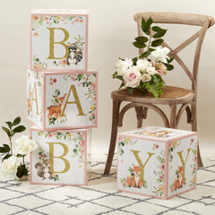 Gold-letter BABY on Kate Aspen Pink Woodland Baby Boxes creates a focal prop for photos.