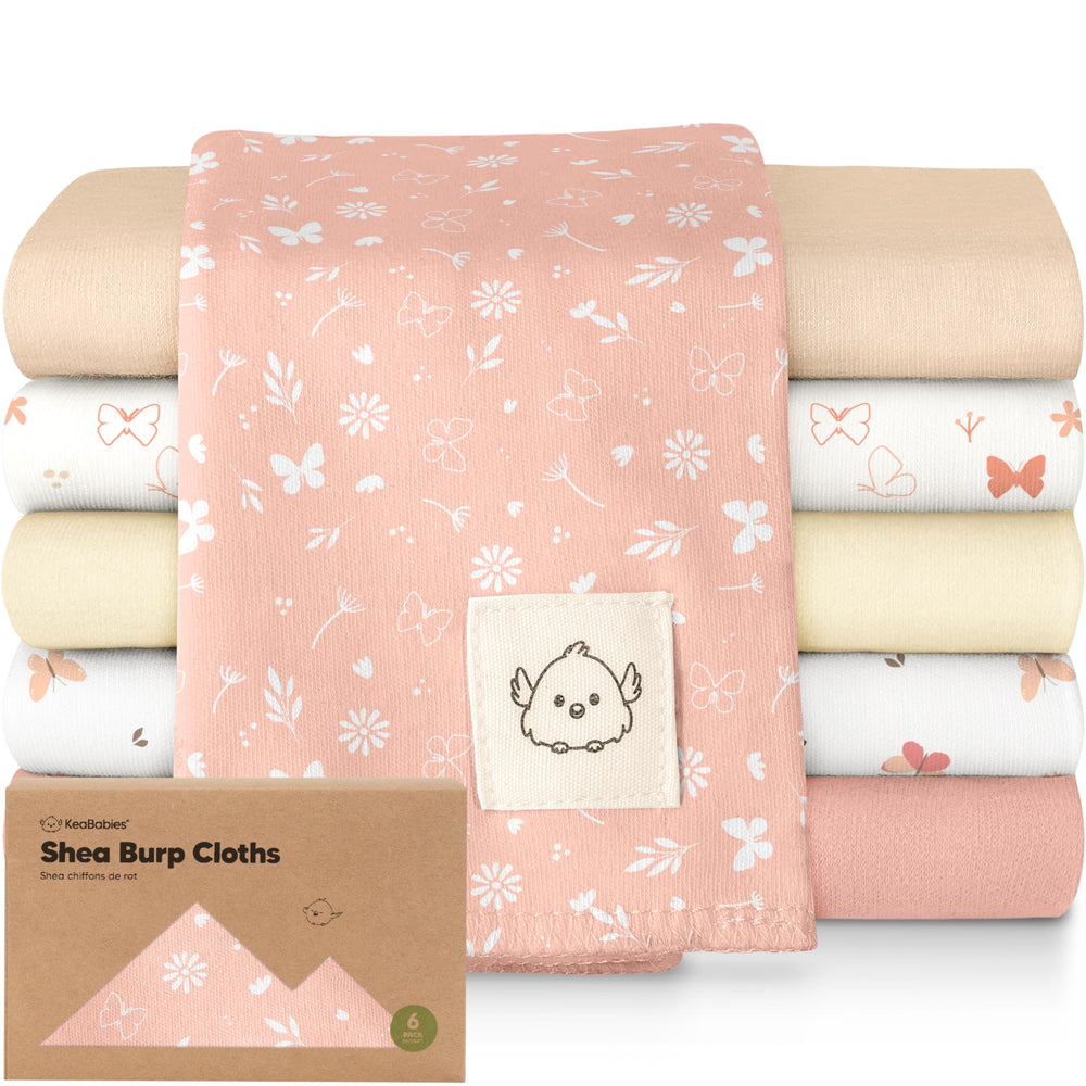 KeaBabies butterfly-pattern burp cloth catching spit-ups during feeds