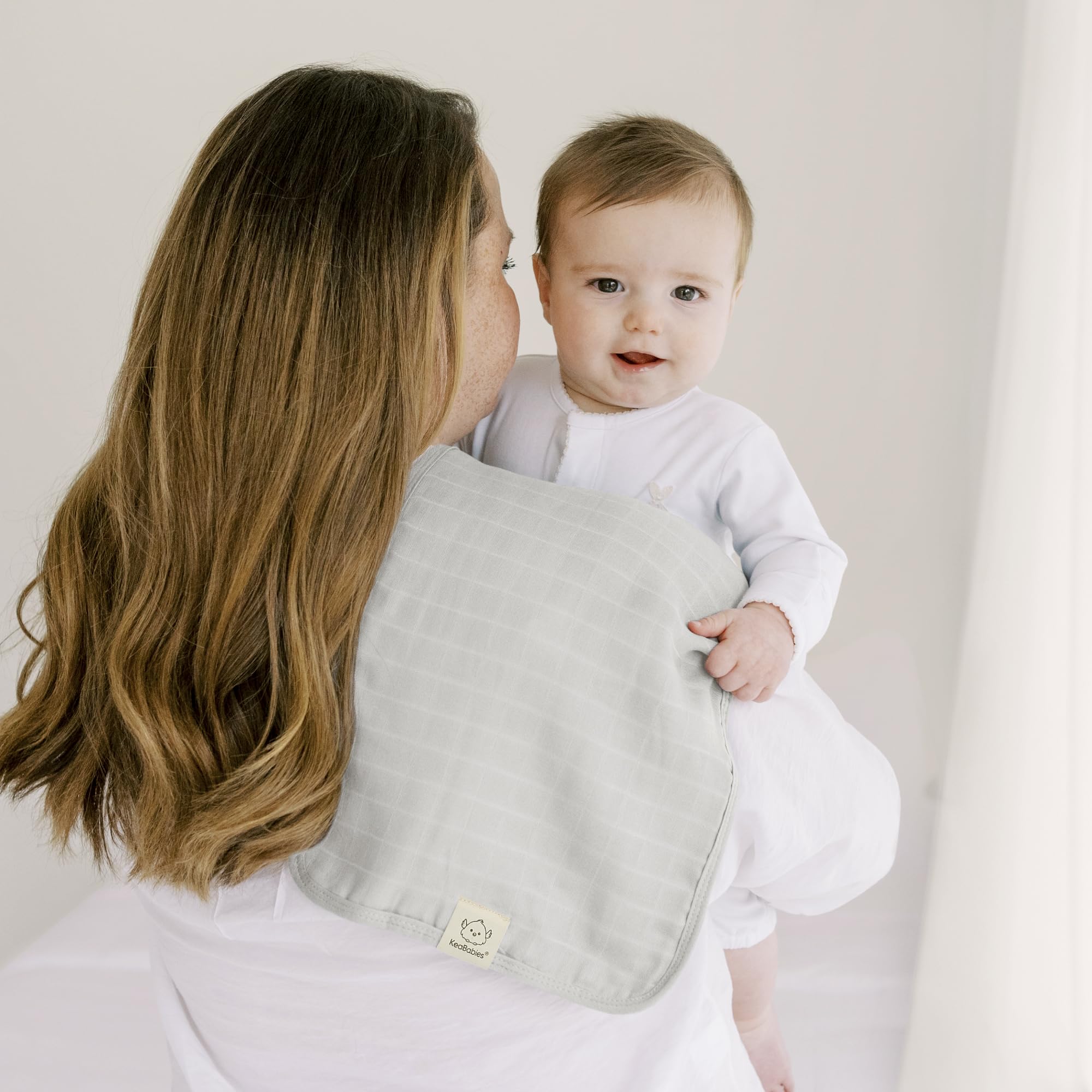 KeaBabies Lumi burp cloth tucked in a diaper bag for on-the-go use.