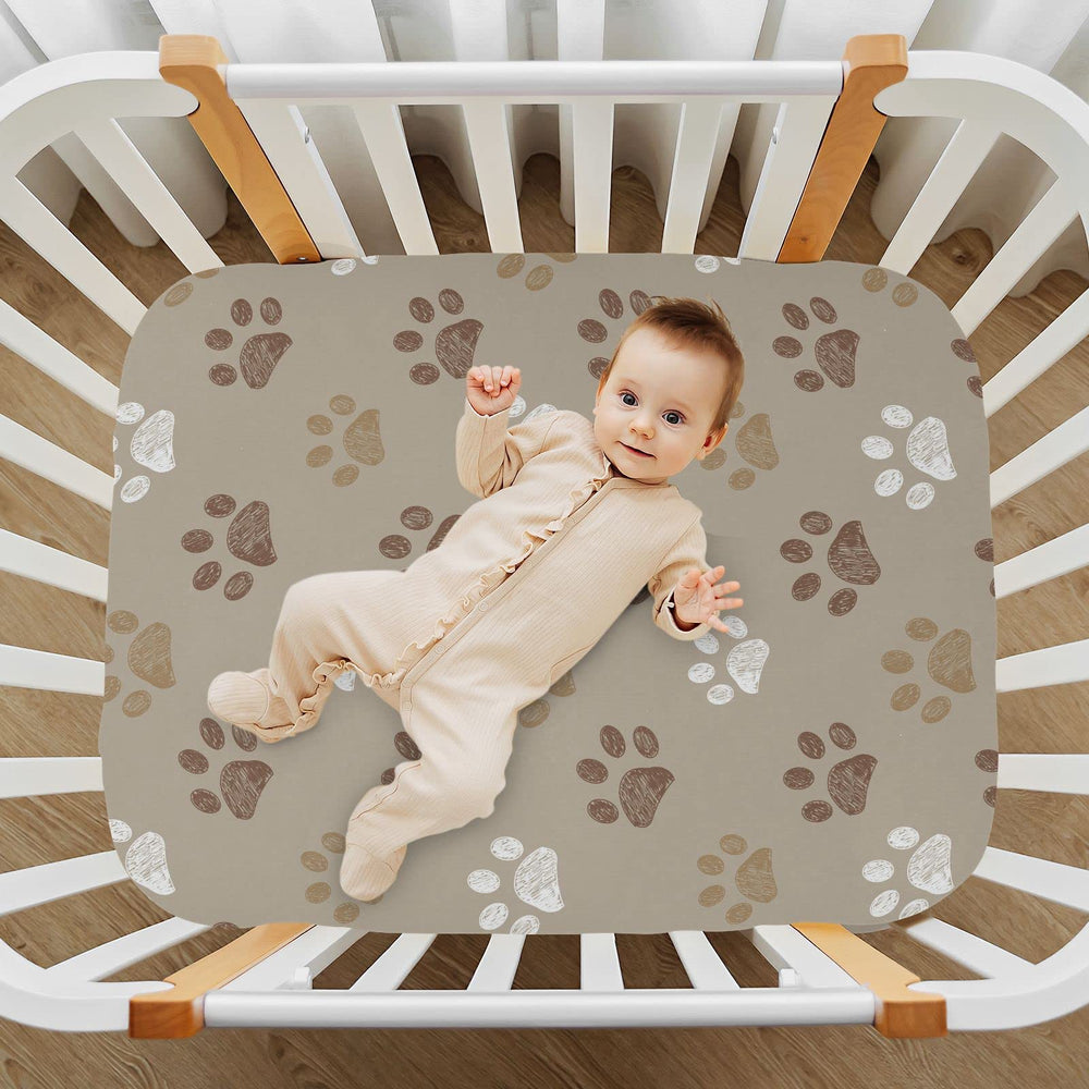 KICPOAY brown dog paws crib sheet on mattress demonstrating a secure fit.