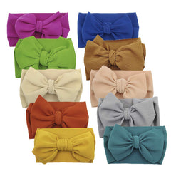 KIDOCHEESE big bow headband in soft fabric with non-slip grip for newborns and toddlers.