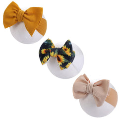 KIDOCHEESE Big Bows pink headband with soft fabric for comfortable newborn wear.