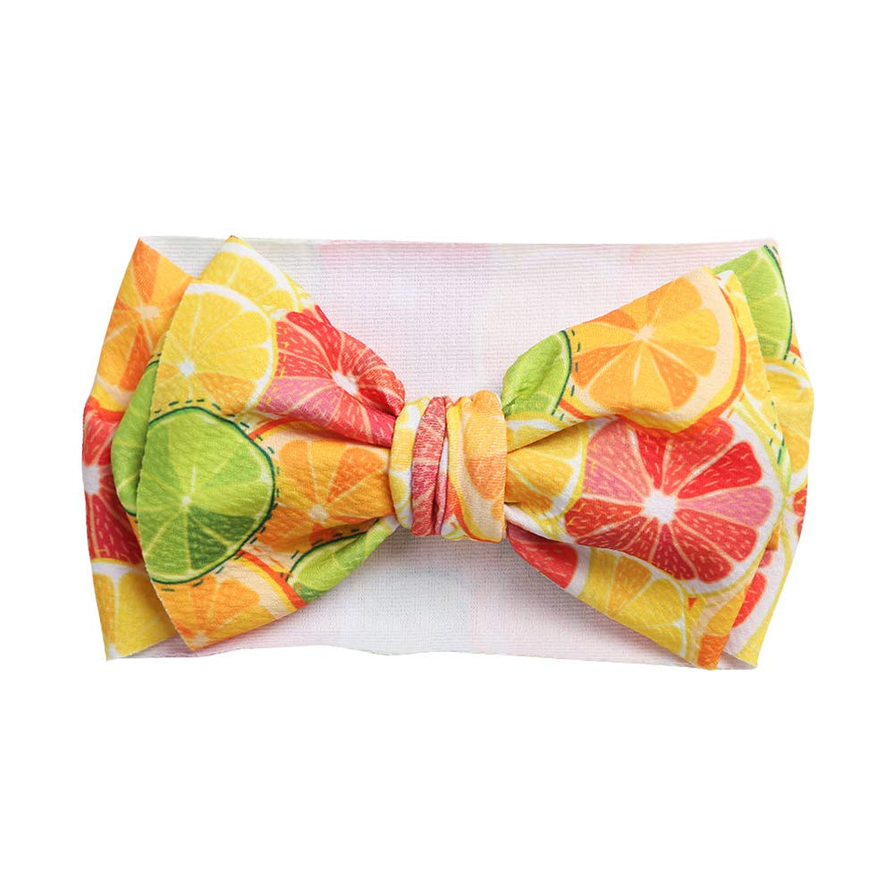 KIDOCHEESE large bow headband closeup highlights plush texture and secure stretch.