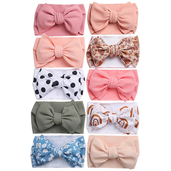 KIDOCHEESE oversized bow headband for newborns with soft elasticity, gentle on delicate heads.
