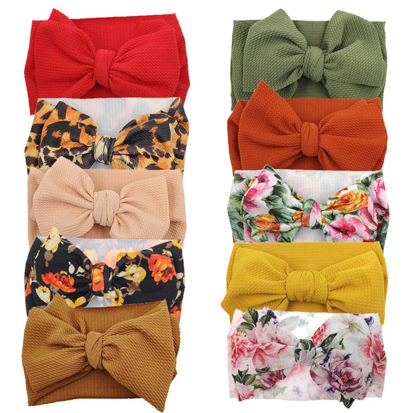 KIDOCHEESE oversized bow headband with soft elastic for newborn comfort.
