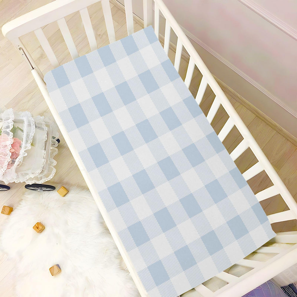 Kigai blue gingham sheet on playpen area as multipurpose pad.
