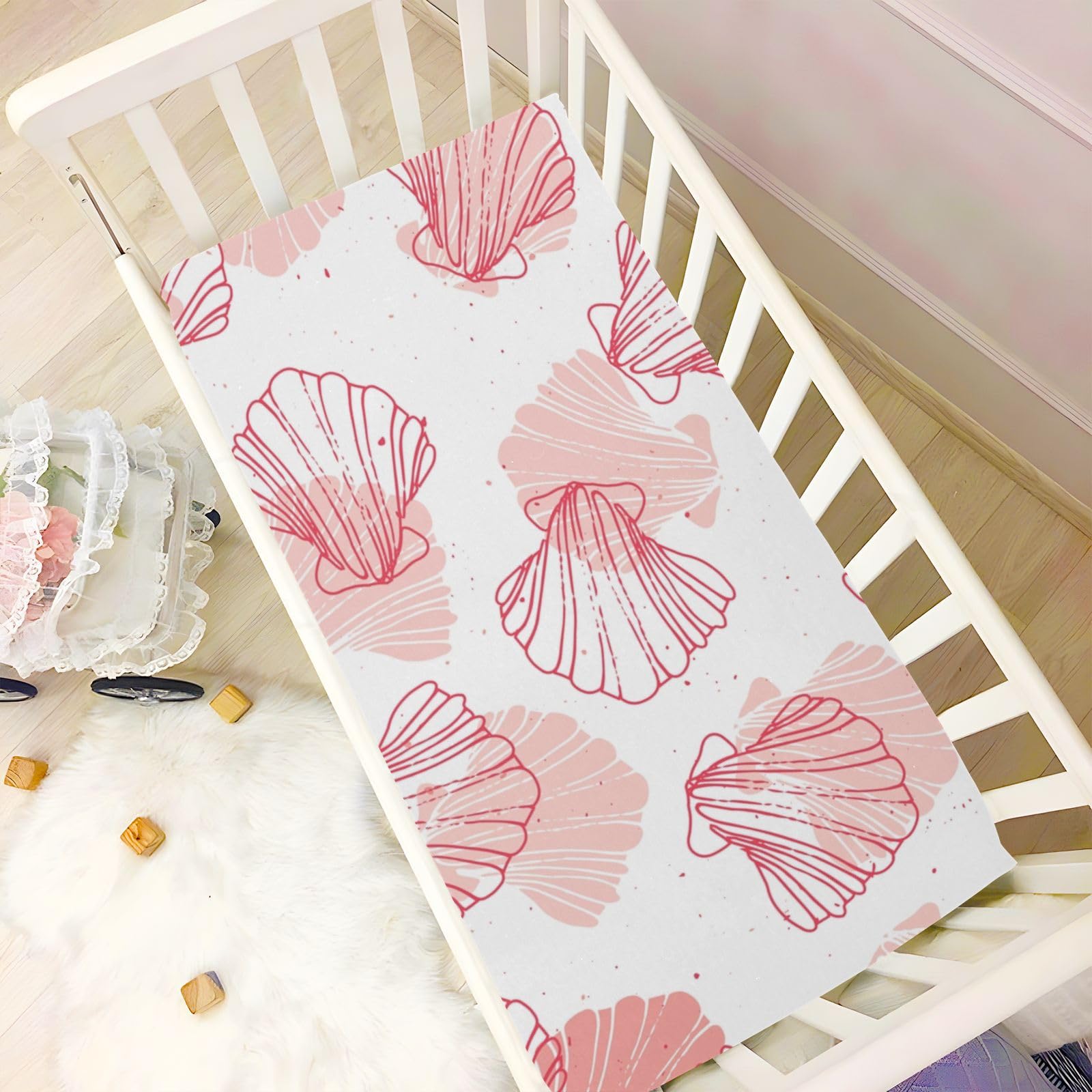 Kigai coral seashell and buffalo plaid design accents nursery