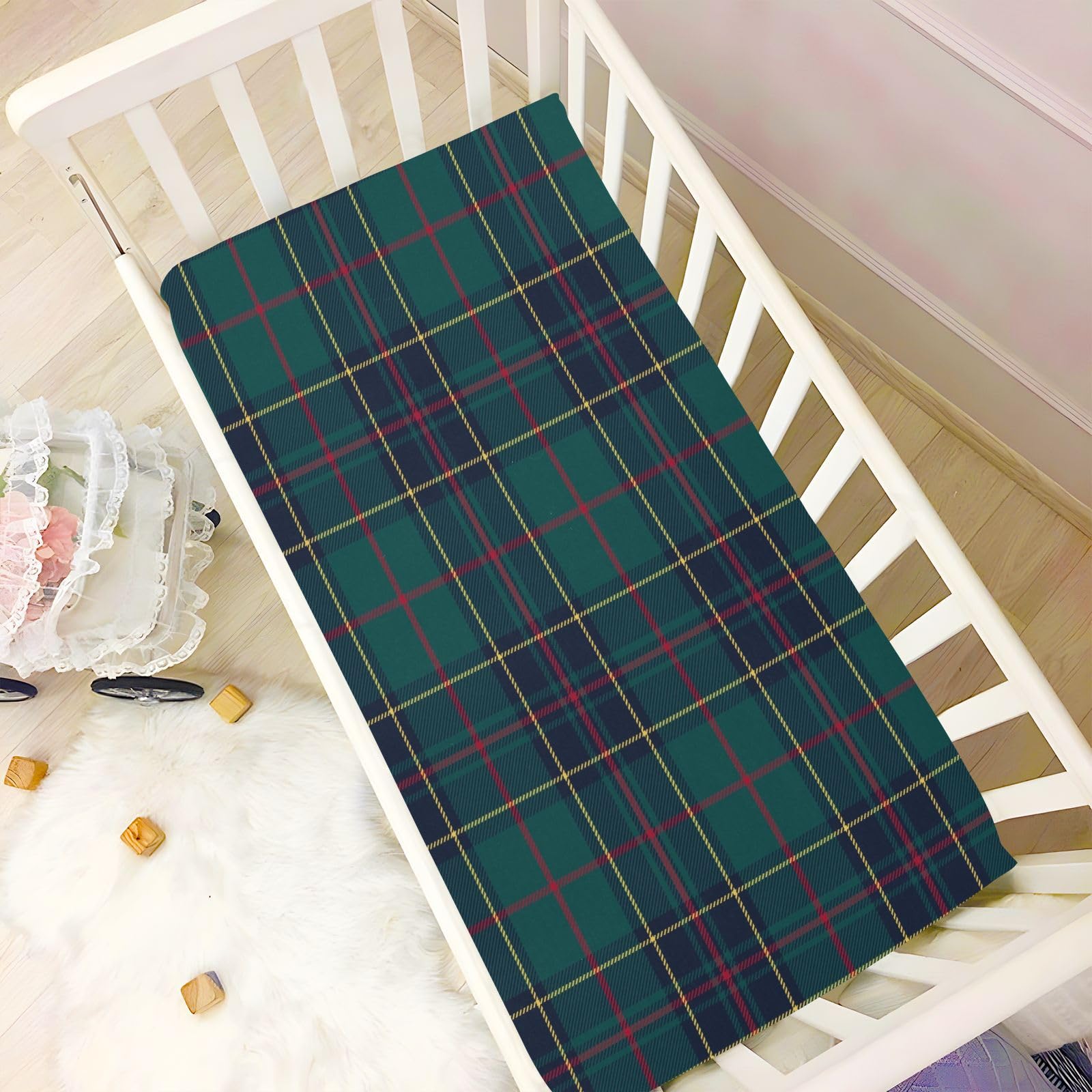Kigai crib sheet used as a diaper changing pad for busy days