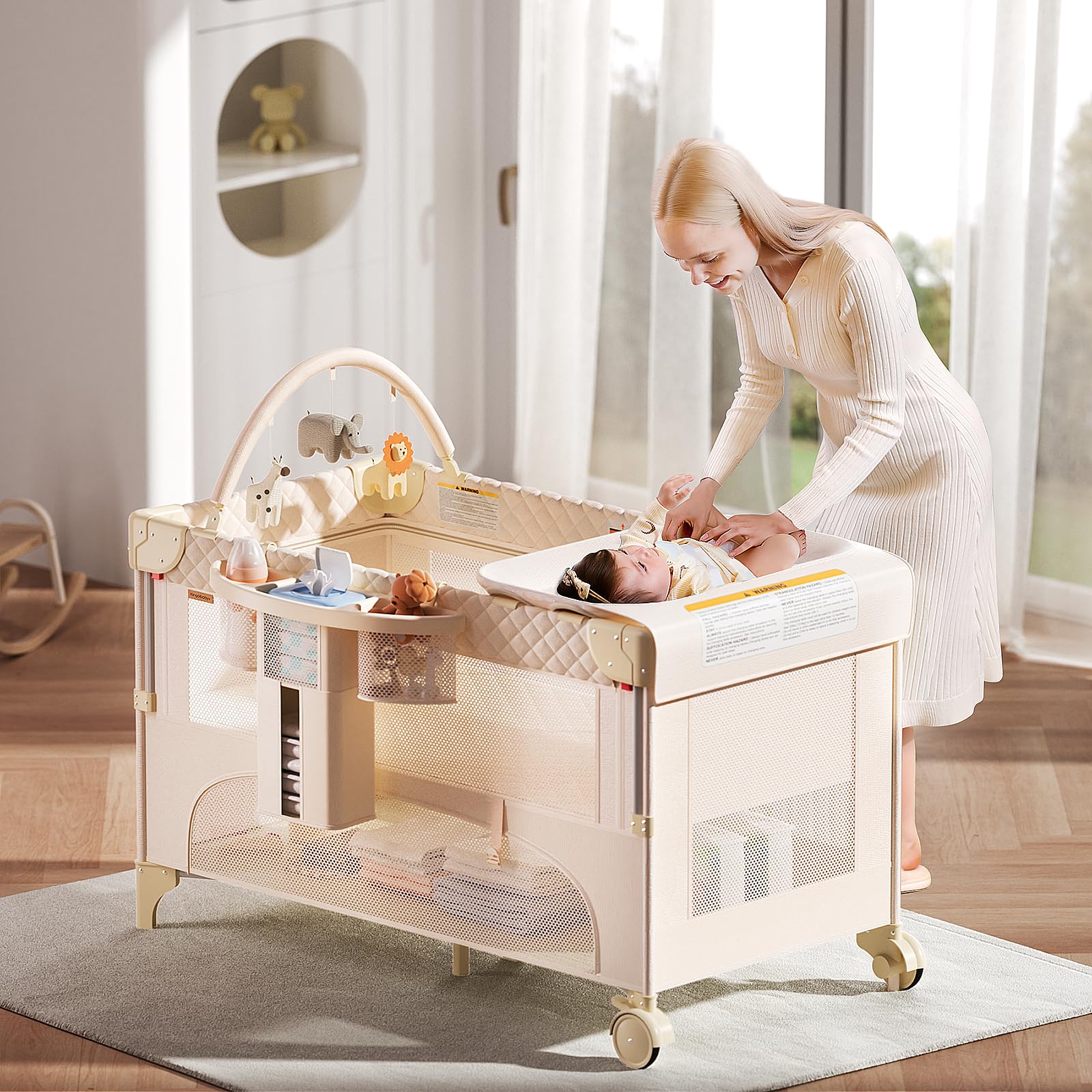 Kingobabys bassinet features removable arch toy shelf and mosquito net.