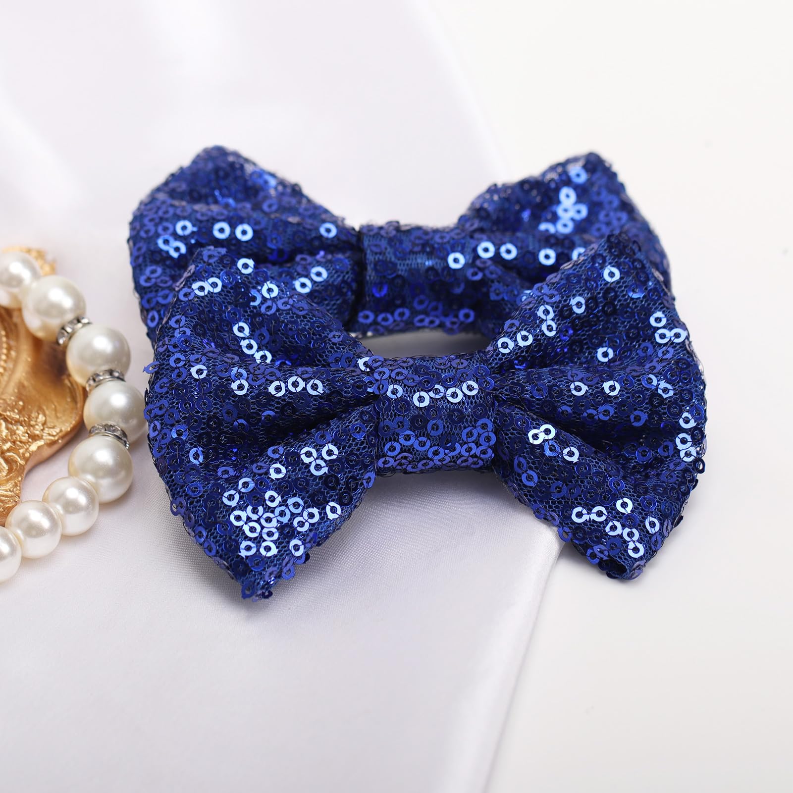 KISZU deep blue sequin bow clip close-up displaying sparkle