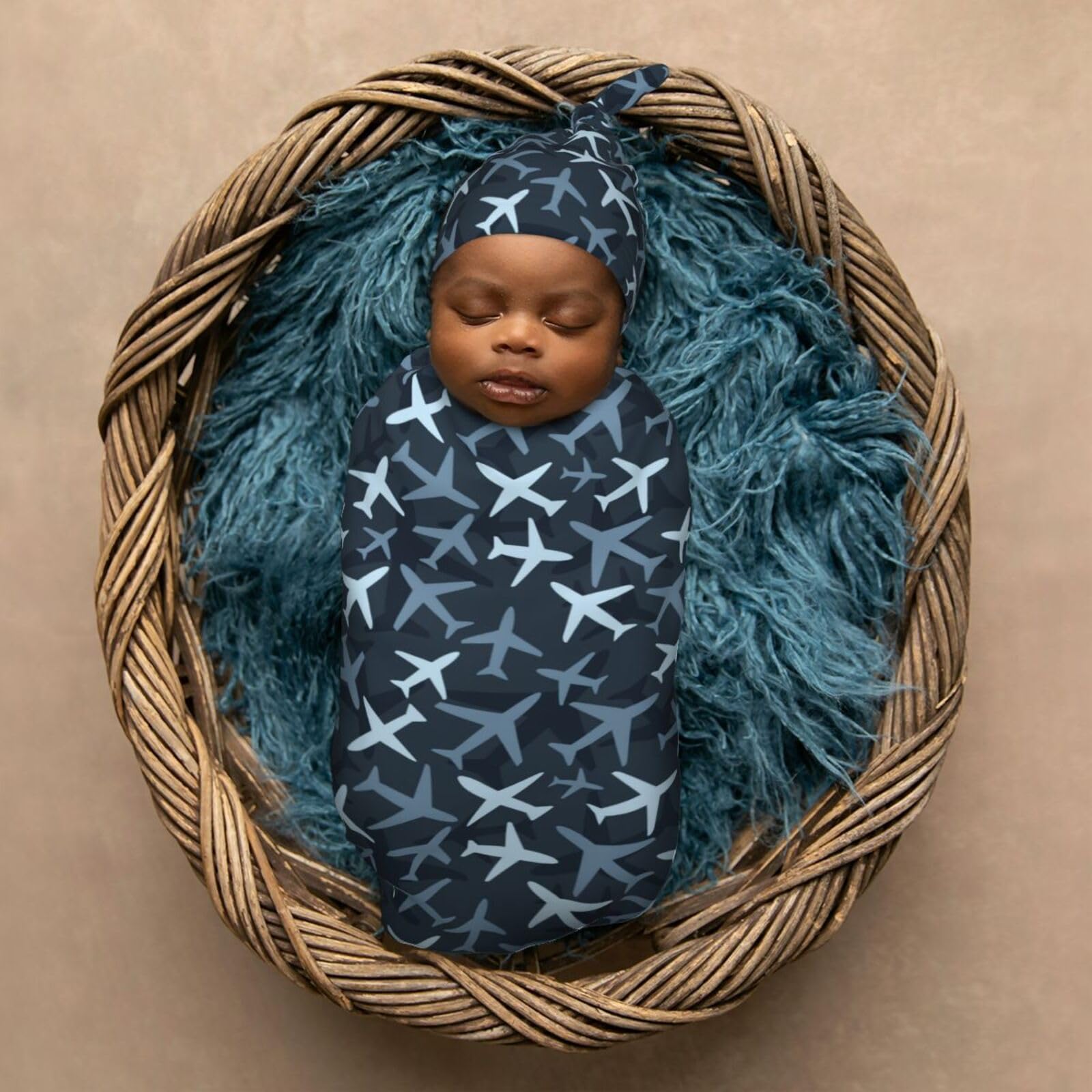 KiuLoam camouflage blue jets baby-model demonstrates easy-to-wear cocoon care.
