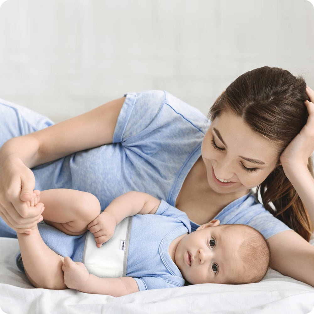 Baby resting calmly with the Knirose Snuggle Strap for a secure feel.
