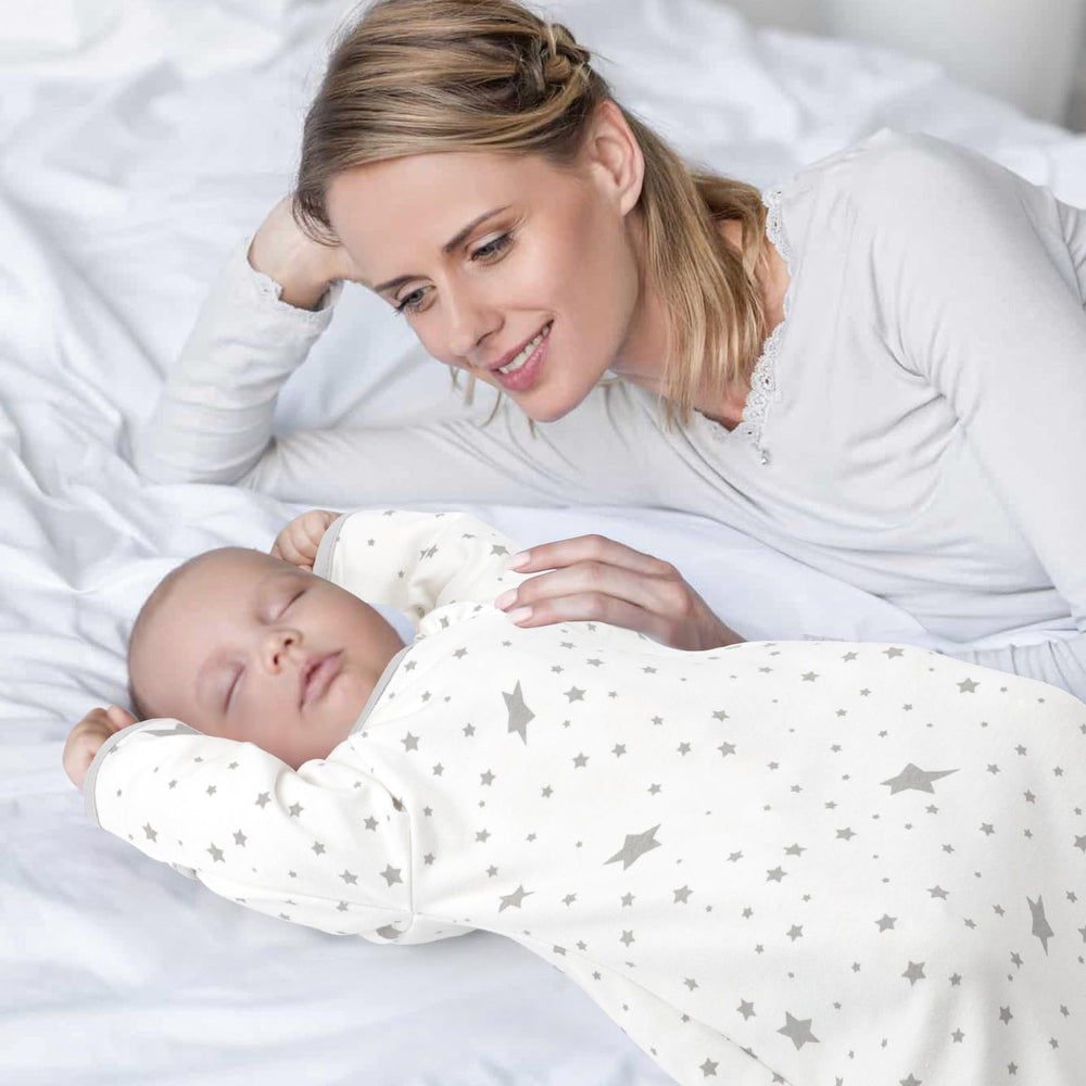 Knirose newborn-to-toddler style baby wearing the sleep sack in bed scene.