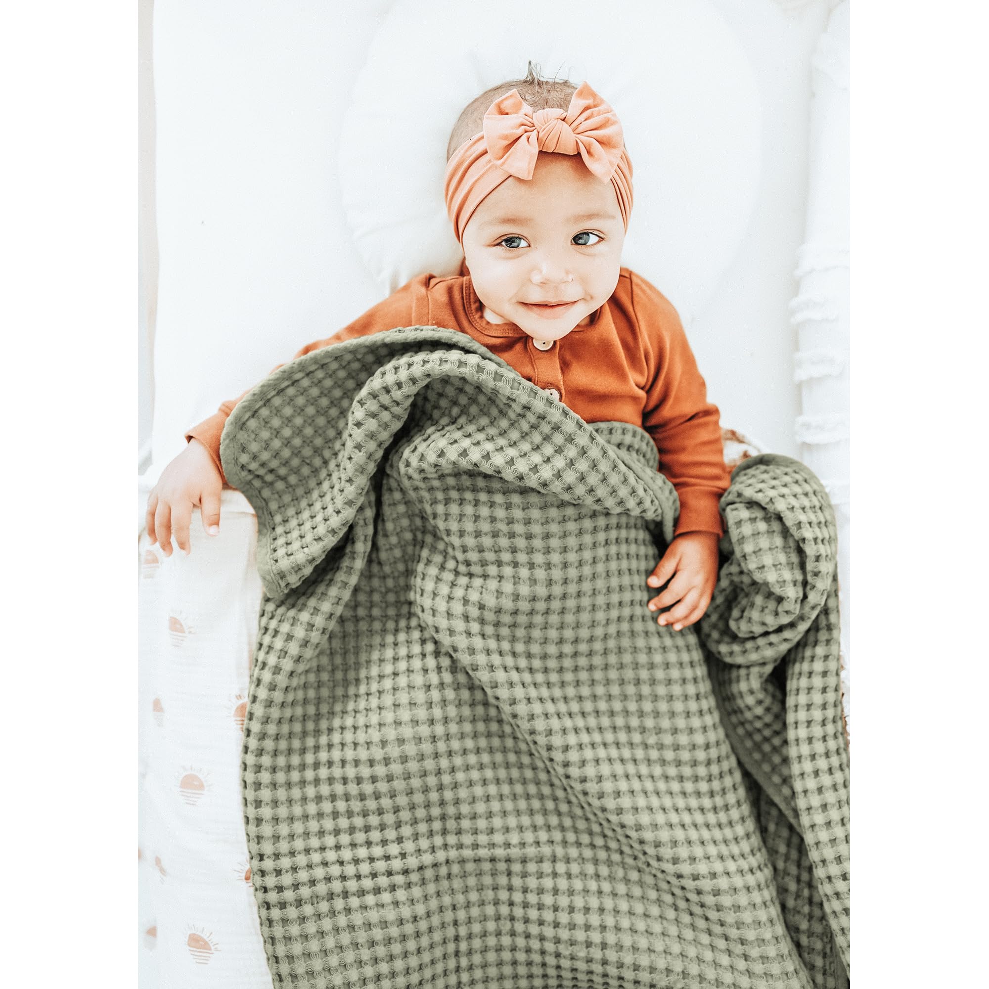 Nursery setup featuring Konssy Amy Green waffle blanket.