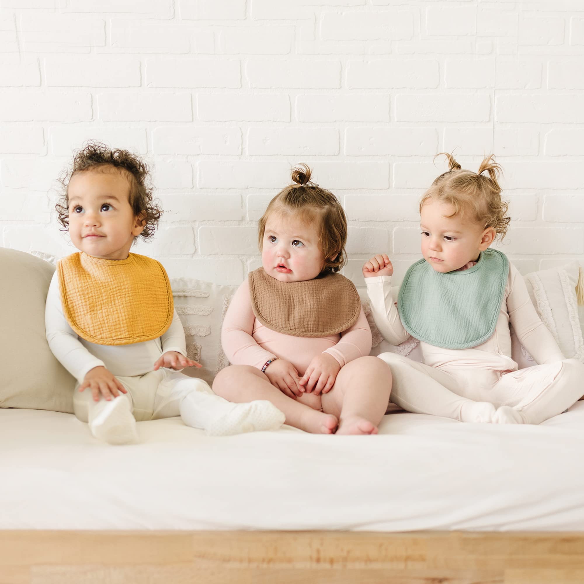 Konssy baby bibs with adjustable nickel-free snaps for growing necks.