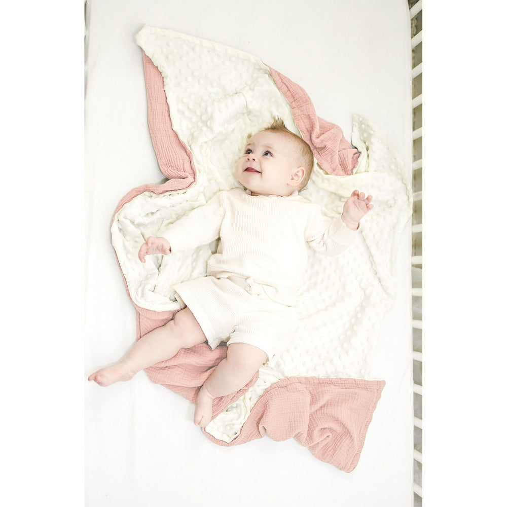 Konssy baby blanket shown swaddled for newborn snugness