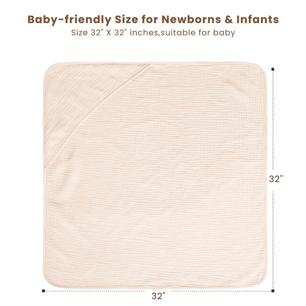 A baby wrapped in cream Konssy hooded towel after bath for warmth