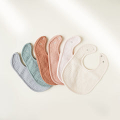 Konssy muslin baby bib back view highlighting absorbent fleece backing.