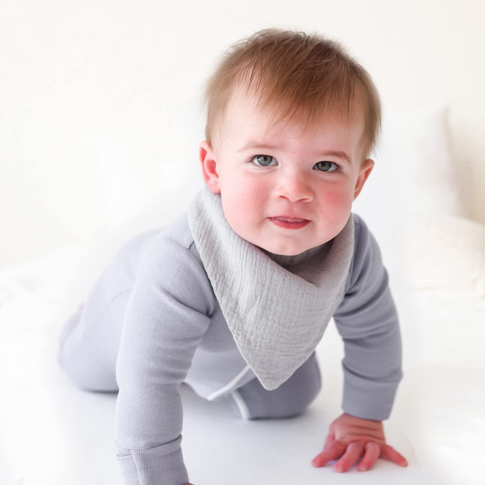 Soft absorbent muslin fabric detail close-up emphasizes breathable texture.