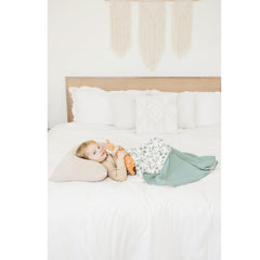 Konssy muslin blanket on nursery decor with gender-neutral green leaves design.