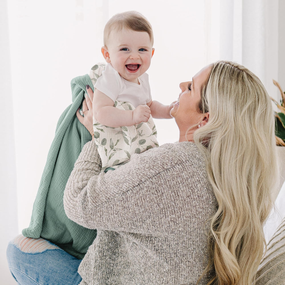 Konssy muslin blanket draped over sofa for cozy toddler moments.
