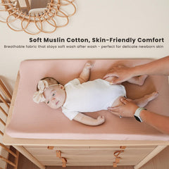 Konssy cream muslin changing pad cover on a standard changing pad for unisex use.