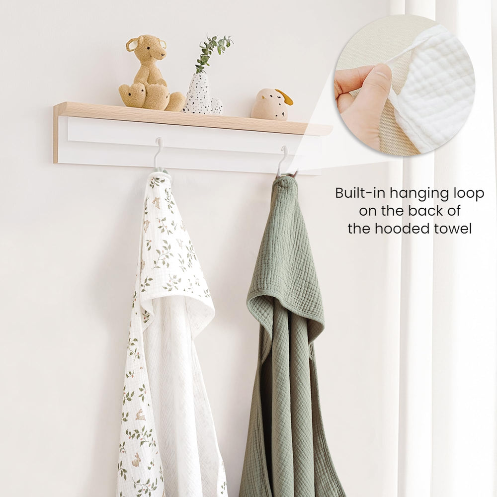 Konssy muslin hooded towel wrapped around a baby, cozy and warm after bath.
