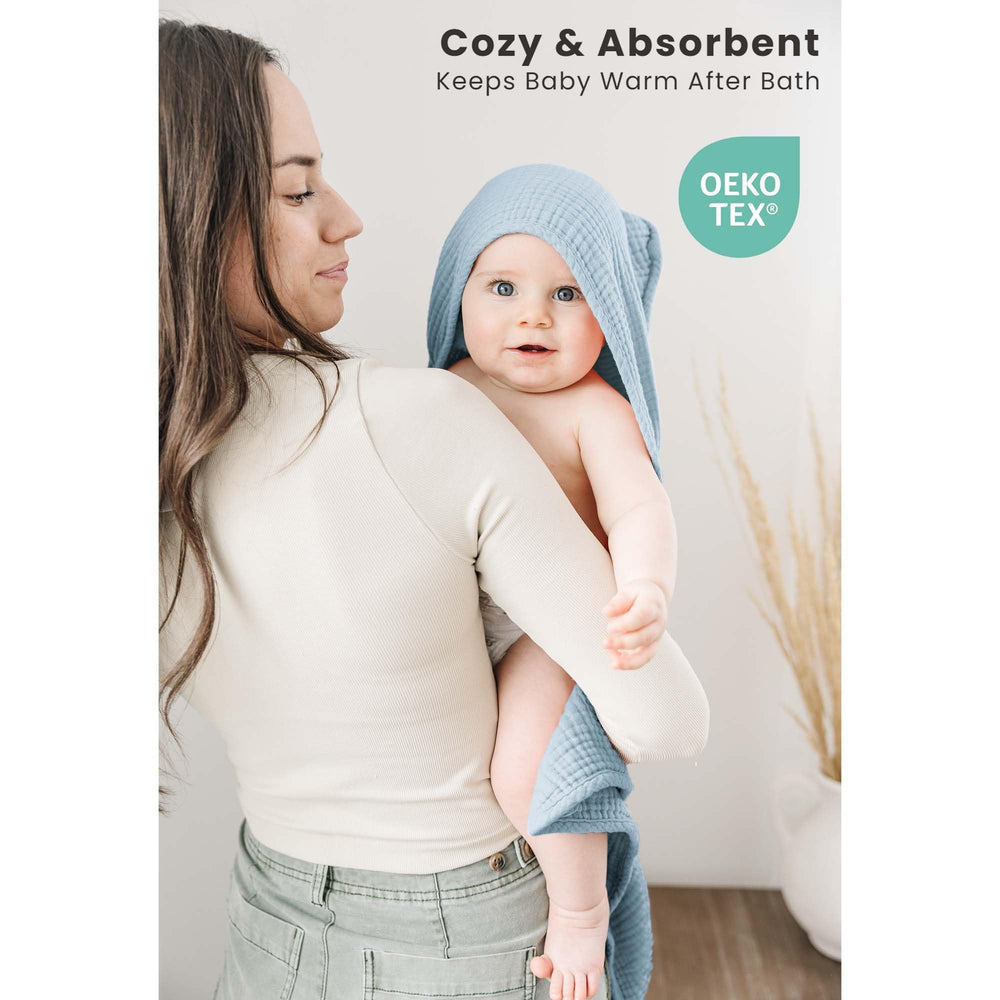Konssy hooded towel on a baby after bath, securing warmth.
